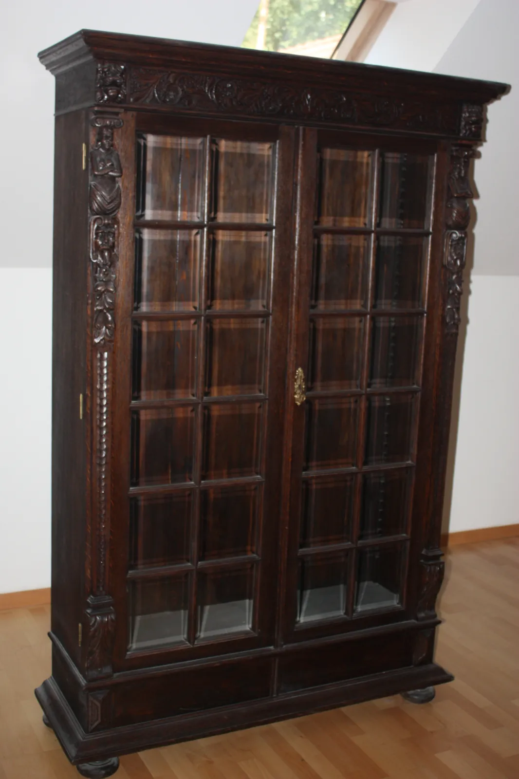 Antyczna biblioteka z rzeźbieniami – masywna szafa przeszklona w stylu historycznym